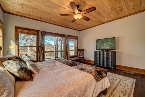 a bedroom with a bed and a ceiling fan at Highland Harmony in Ellijay