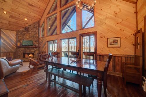 a dining room with a table in a cabin at Highland Harmony in Ellijay