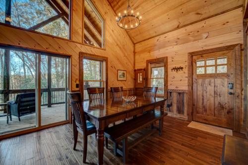 a dining room with a wooden table and chairs at Highland Harmony in Ellijay
