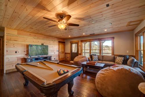 a living room with a pool table and a ceiling at Highland Harmony in Ellijay