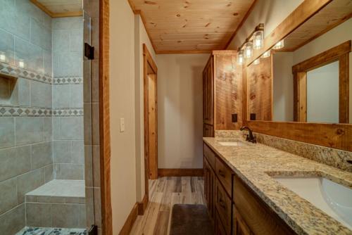 a bathroom with a tub and a sink and a shower at Highland Harmony in Ellijay