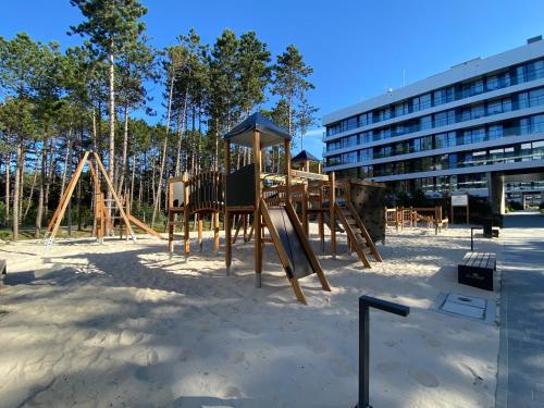 a playground in front of a building at HO!HOUSE SHELLTER ROGOWO in Rogowo