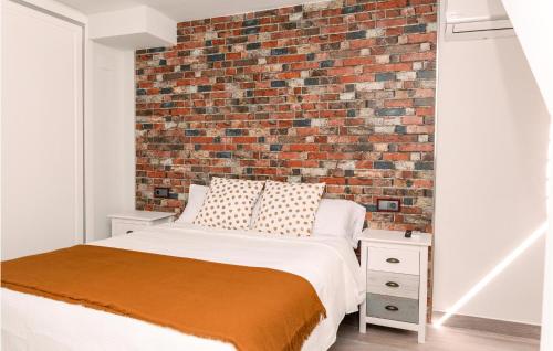 - une chambre avec un mur en briques et un lit dans l'établissement 2 Bedroom Lovely Home In Isla Cristina, à Isla Cristina