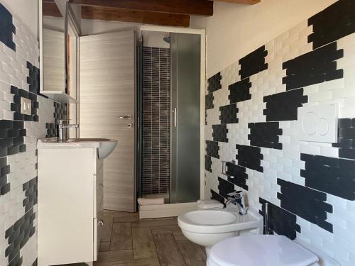 a bathroom with a white toilet and a sink at Chill Sorso in Sorso