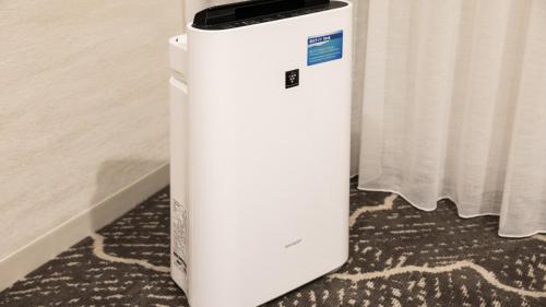 a white refrigerator sitting on the floor next to a curtain at JR-East Hotel Mets Kamakura Ofuna in Kamakura