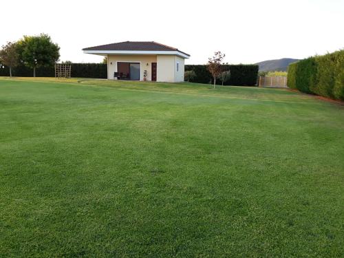 a house with a large lawn in front of it at Galini Estate in Karditsa