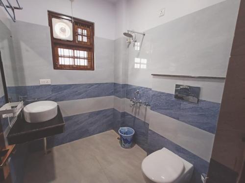 a bathroom with two toilets and a sink at SIDDHARTHA INN in Lucknow