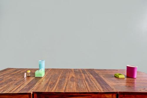 un tavolo in legno con quattro diversi contenitori colorati sopra di SPOT ON 91716 Kost Yy Syariah a Mojokerto
