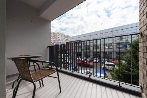 a balcony with a chair and a view of a parking lot at Ines in Bucharest
