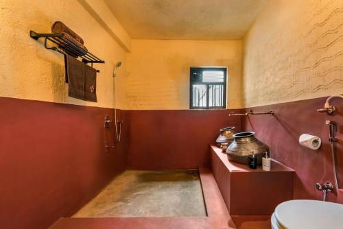 a bathroom with a sink and a toilet in it at SaffronStays Sattva - pet and eco-friendly villa in Mumbai's outskirts in Pen