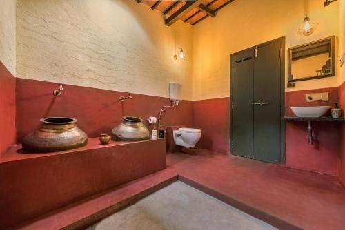 a bathroom with a toilet and a sink at SaffronStays Sattva - pet and eco-friendly villa in Mumbai's outskirts in Pen