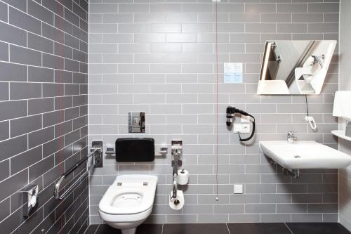 a bathroom with a white toilet and a sink at Holiday Inn Express - Offenburg by IHG in Offenburg