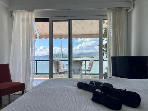 a bedroom with a bed with a view of the ocean at Marine Apartment with sea & port view! in Volos
