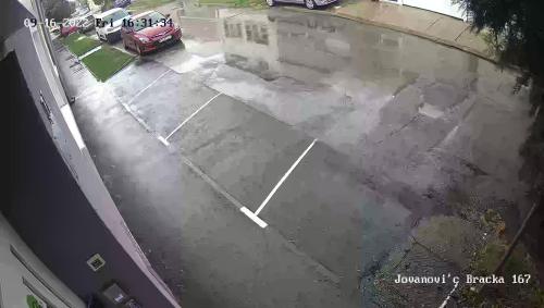 an empty parking lot with a car parked in a driveway at InOsijek- FEELS LIKE HOME in Osijek