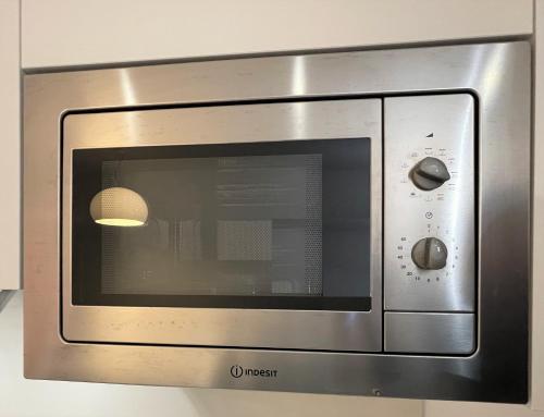 a stainless steel microwave oven in a kitchen at MONNALISA VENICE APARTMENT in Venice