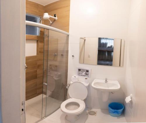 a bathroom with a shower and a toilet and a sink at Hostel Diniz in Vitória