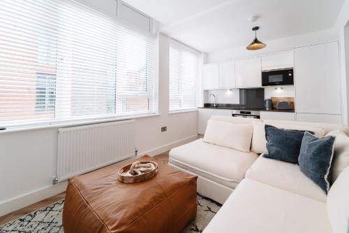 a living room with a white couch and a table at Royal House Stylish Apartments - Chester in Chester