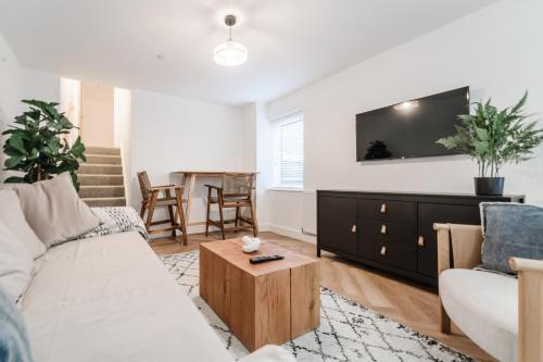 a living room with a couch and a table at Royal House Stylish Apartments - Chester in Chester