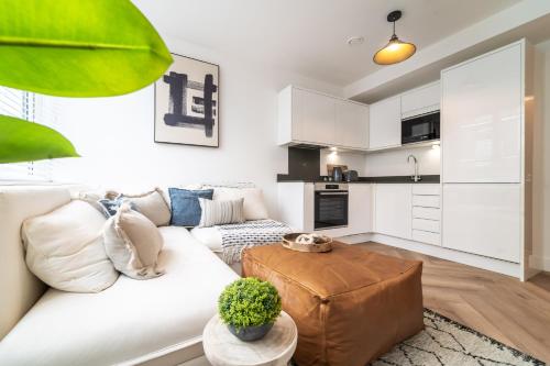 a living room with a white couch and a table at Royal House Stylish Apartments - Chester in Chester