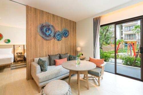 a living room with a couch and a table at Holiday Inn Resort Samui Bophut Beach by IHG in Bophut 