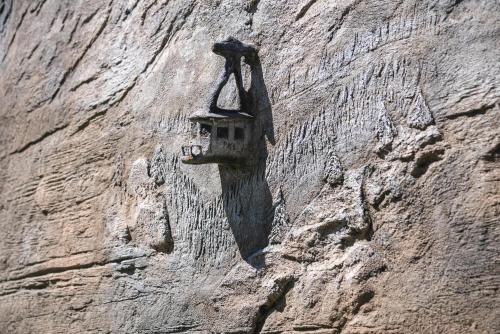 a rock wall with a bird house on it at Hotel Górski in Białka Tatrzanska