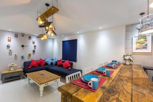 a living room with a blue couch and a wooden table at My Way in Ras al Khaimah
