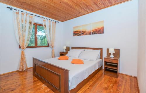 a bedroom with a bed and a wooden ceiling at Cozy Home In Runovic With Outdoor Swimming Pool in Runović