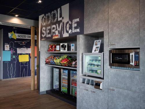 a grocery store with a refrigerator and a microwave at ibis budget Oostende Airport in Ostend