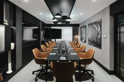 a conference room with a long table and chairs at Radisson Collection Hotel, Warsaw in Warsaw