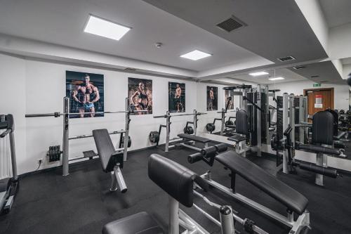 a gym with lots of equipment and posters on the wall at Hotel Górski in Białka Tatrzanska