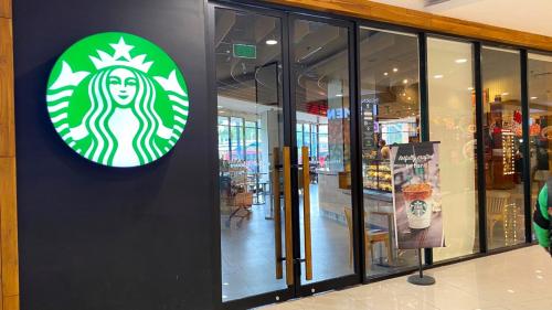 a starbucks sign on the side of a store at HARRIS Hotel & Convention Festival Citylink Bandung in Bandung