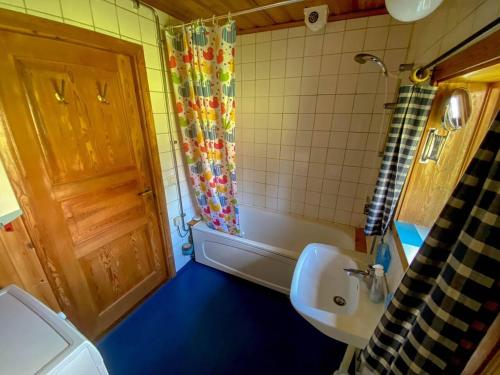 a bathroom with a toilet and a sink and a door at Beautiful 4-5 persons Cottage in Alvdalen in Älvdalen