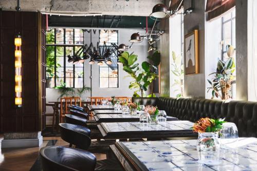 a dining room with a long table and chairs at Gorgeous George by Design Hotels ™ in Cape Town