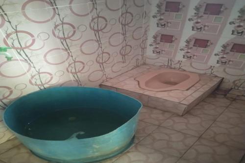 a bathroom with a bath tub and a sink at EXPRESS O 91702 Mandeh Homestay Syariah in Painan
