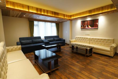 a living room with couches and a couch and a table at Mount Magnolia Boutique Hotel & Spa in Pelling