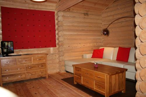 a living room with a couch and a table at BCC Loch Ness Log Cabins in Bearnock