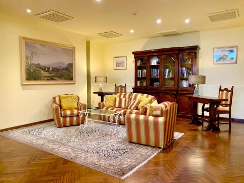 a living room with two chairs and a table at Hotel Isabella in Taormina