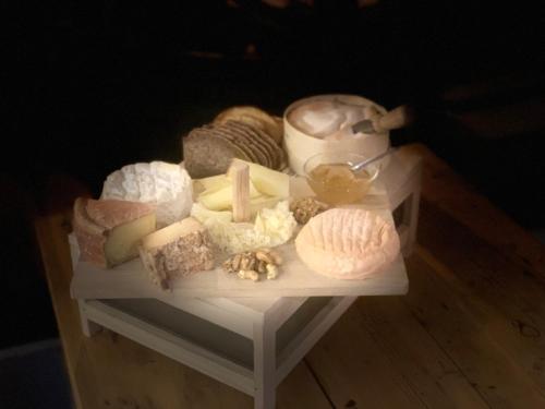 a white table with cheese and other foods on it at Hôtel Restaurant Eden in Evolène