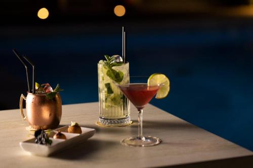 two cocktails sitting on top of a table at Hotel Excelsior in Marina di Massa