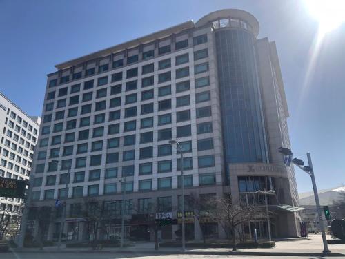 a large office building with a lot of windows at Incheon Airport Guesthouse in Incheon