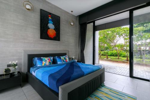a bedroom with a blue bed and a large window at Colossus by StayVista - Riverside luxury villa in Khalapur with a Spacious pool, Sauna, Private theater, Gazebo & Lawn in Lonavala