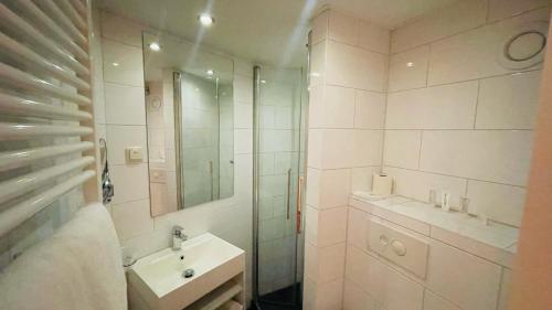 a white bathroom with a sink and a shower at Prinsengracht Hotel in Amsterdam