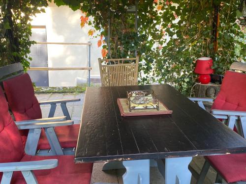 a wooden table with two chairs and a book on it at Agroturystyka Staroscin in Rzepin