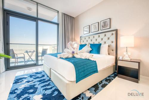 a bedroom with a bed with a large window at Peaceful Studio at Celestia A Dubai South by Deluxe Holiday Homes in Dubai