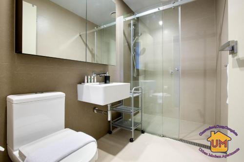 a bathroom with a shower and a toilet and a sink at Aussie Escape Apartments in Melbourne
