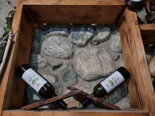two bottles of wine in a wooden box at safari house in Tbilisi City