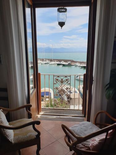 a room with a view of the ocean from a balcony at Kalimaka Bed & Breakfast in Scario