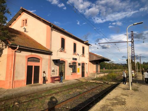 a train station with people standing outside of a building at Magalas Studio in Magalas