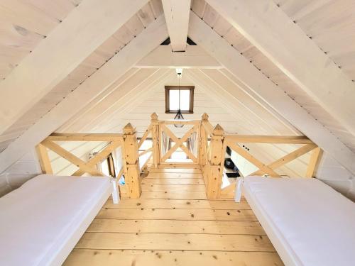 a tiny house with two beds in the attic at KOPUVA in Nida
