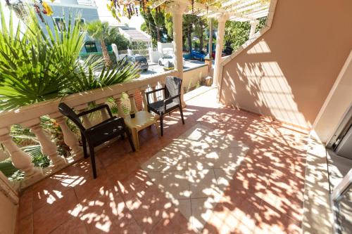 a balcony with two chairs and a table at Melis Hotel Kusadasi in Kusadası